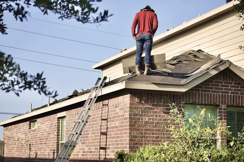 Professional roofer working on a residential roof in Comfort
